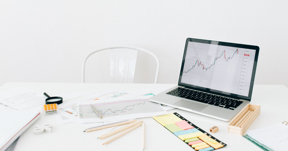 Laptop with analytics chart and business reports on desk representing SEO tracking and digital marketing performance
