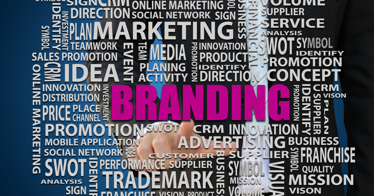 Businessman pointing at branding surrounded by digital marketing keywords like SEO, CRM, and advertising