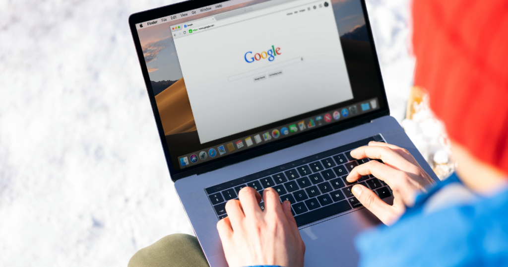 How Local Reviews & Testimonials Fuel SEO Success 1 Person using Google search on a laptop outdoors with snow in the background